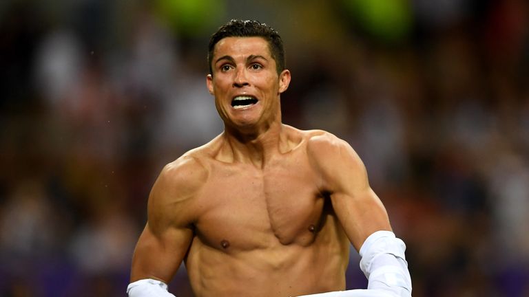 Cristiano Ronaldo of Real Madrid takes off his shirt in celebration after scoring the winning penalty in the Champions League final