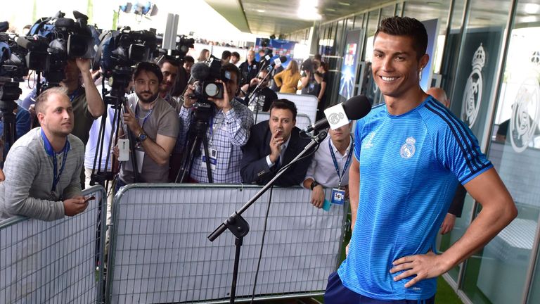 Real Madrid forward Cristiano Ronaldo smiles as he addresses journalists