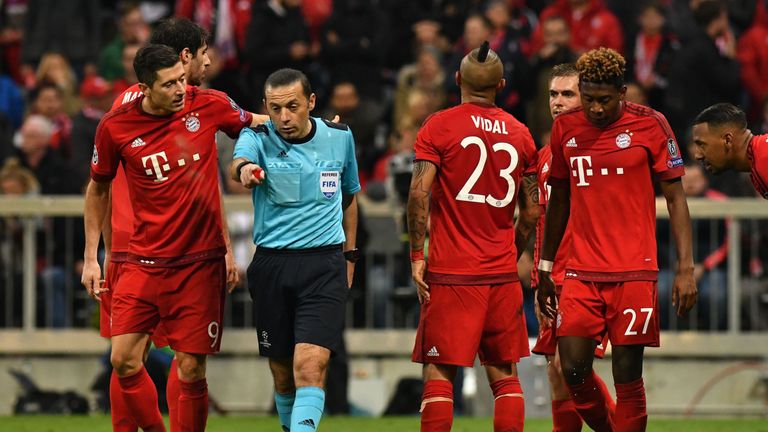 Turkish referee Cuneyt Cakir points to the penalty spot during the UEFA Champions League semi-final, second-leg football match between FC Bayern Munich and