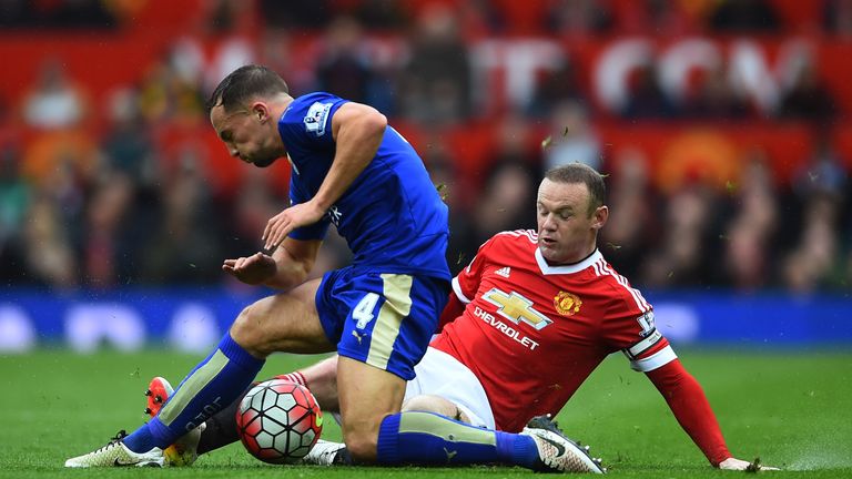 Danny Drinkwater is tackled by Wayne Rooney