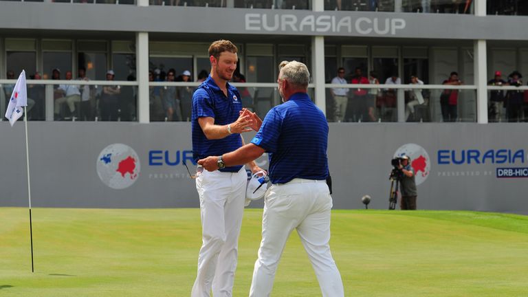 KUALA LUMPUR, MALAYSIA - JANUARY 17:  Darren Clarke, Team Europe Captain congratulates Chris Wood after he contributes another point for Team Europe during