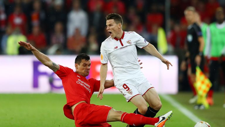  Kevin Gameiro of Sevilla is fouled by Dejan Lovren of Liverpool resulting in an yellow card during the UEFA Europa League Fin