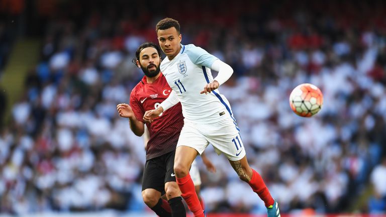 Dele Alli of England battles for the ball with Selcuk Inan of Turkey