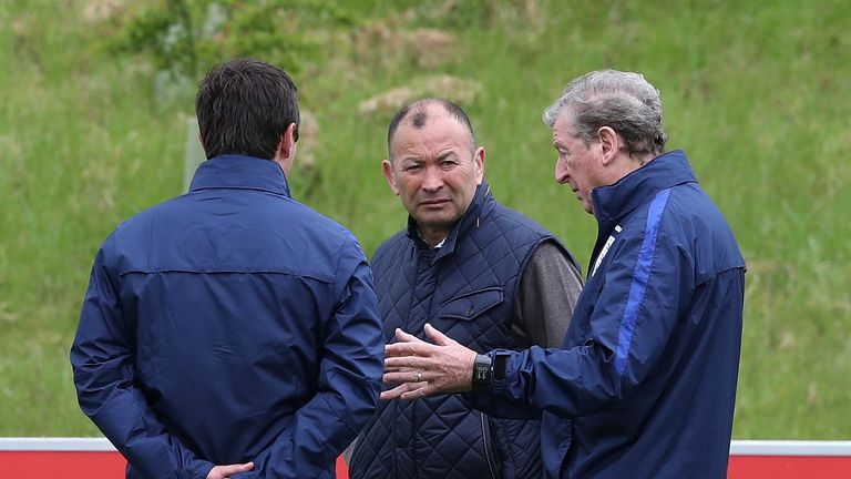 Eddie Jones (middle) talks to Roy Hodgson (right) and Gary Neville at St George's Park