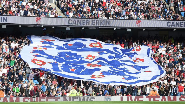 England fans hold a giant banner of the team's logo during the friendly football match between England and Turkey at the Etihad Stadium in Manchester, nort