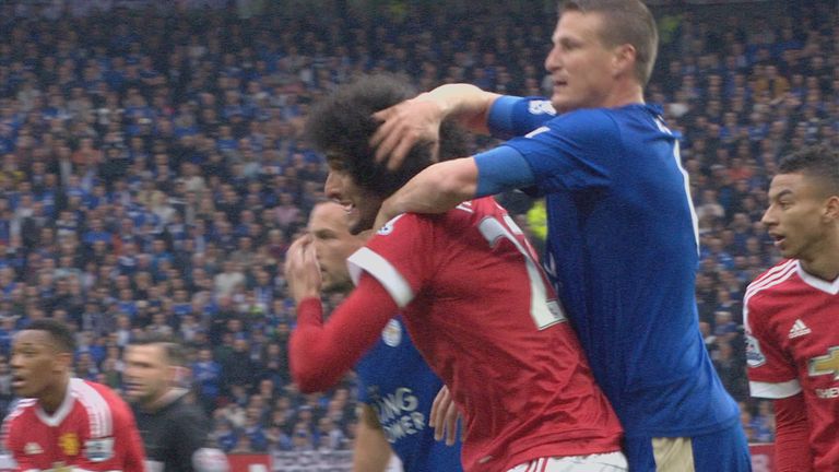 Leicester defender Robert Huth appears to pull the hair of Marouane Fellaini during the game at Old Trafford.