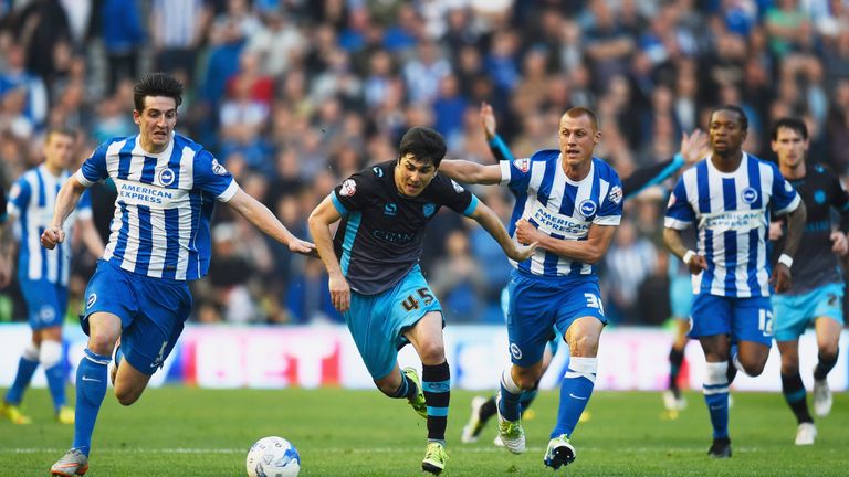 Fernando Forestieri of Sheffield Wednesday (45) is chased by Lewis Dunk (5) and Steve Sidwell of Brighton
