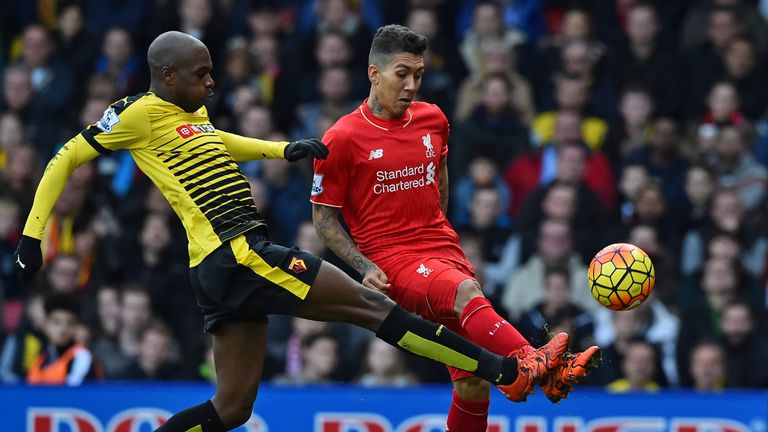 Liverpool's Brazilian midfielder Roberto Firmino (R) has an unsuccessful attempt on goal as Watford's Cameroonian 