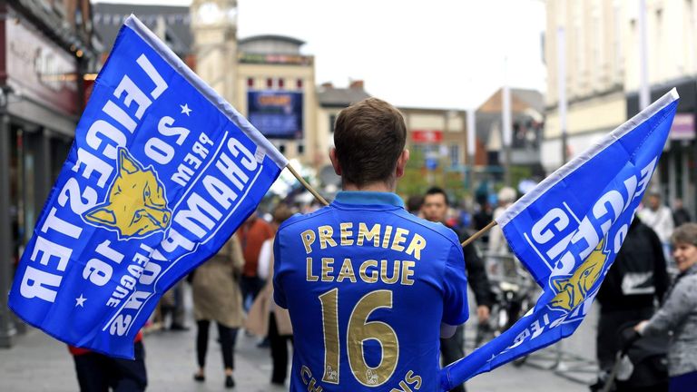 A Leicester City fan shows support for his side ahead of the open top bus parade