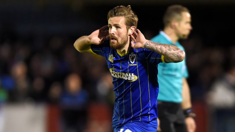 AFC Wimbledon's Tom Beere celebrates scoring his side's first goal of the game during the Sky Bet League Two playoff, first leg match at Kingsmeadow,