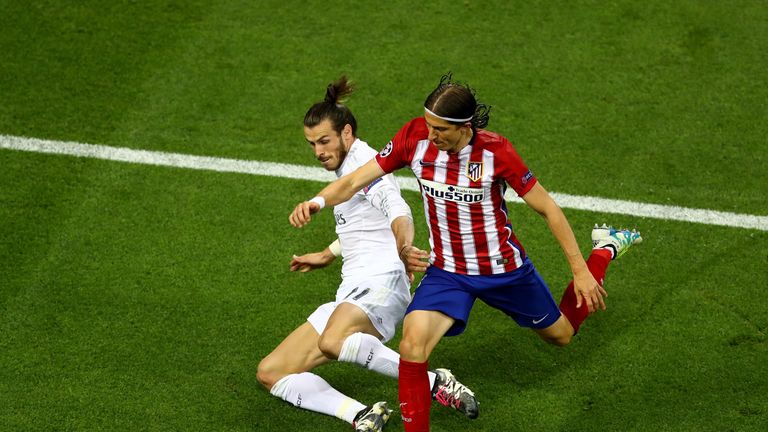 Gareth Bale of Real Madrid is challenged by Filipe Luis of Atletico Madrid during the Champions League final