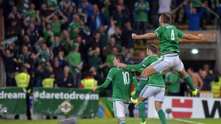 Gareth McAuley (R) celebrates a goal against Hungary in a Euro 2016 qualifier with Kyle Lafferty (L) and Niall McGinn (2nd R)