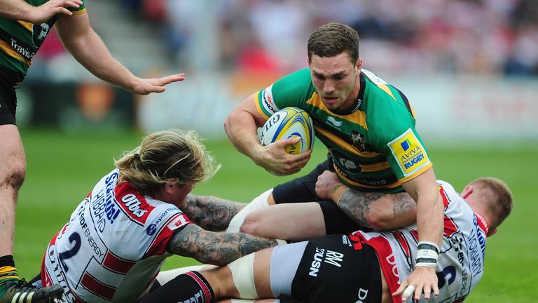 Northampton's George North  is tackled by Gloucester's Richard Hibbard (L) and Ross Moriarty