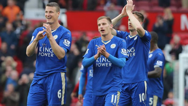 Leicester players cheer the crowd after they gain a point closer to the title