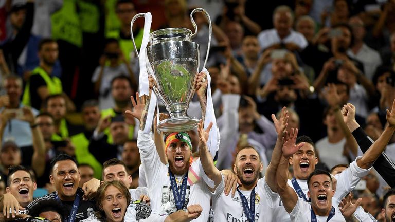 Real Madrid players celebrate with Champions League trophy