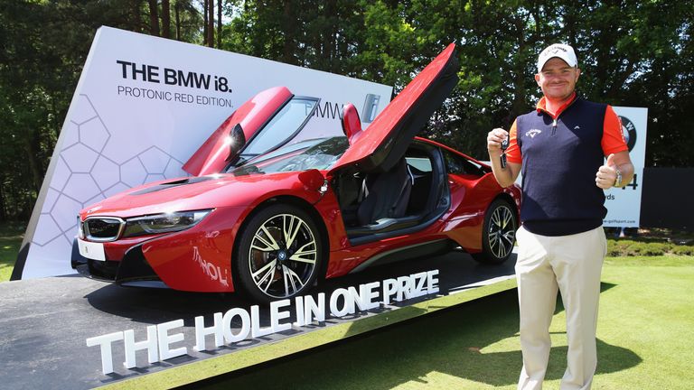 James Morrison of England poses with his new BMW i8 car after his hole-in-one on the 14th during day four of the BMW PGA