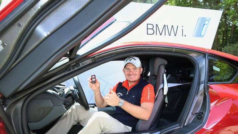 James Morrison of England sits in his new BMW i8 car after his hole-in-one on the 14th during day four of the BMW PGA
