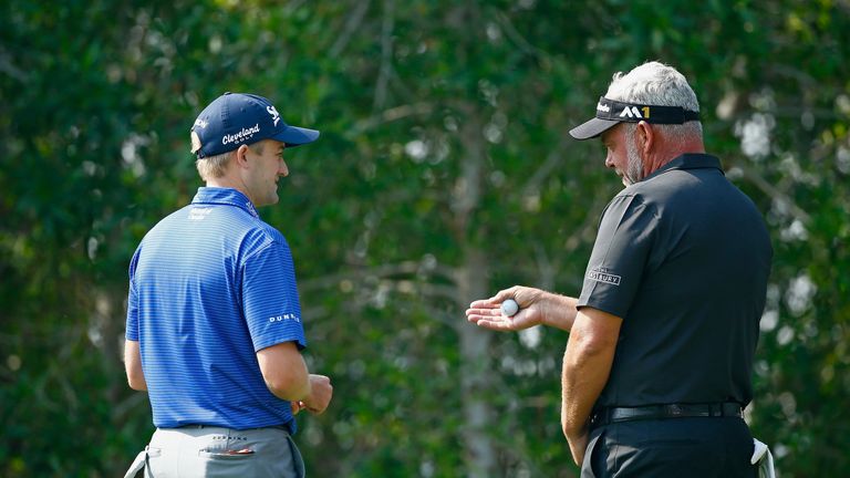 Russell Knox (L) chats to Darren Clarke