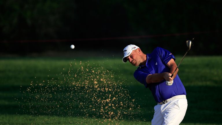 Thomas Bjorn plays his third shot at the par 4, 14th hole