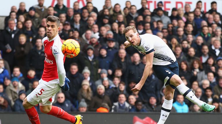 Harry Kane of Tottenham Hotspur shoots past Gabriel of Arsenal