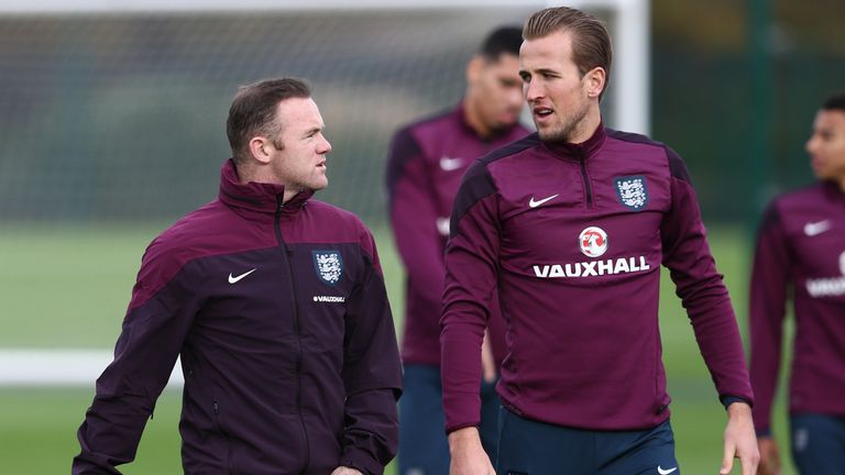 England captain Wayne Rooney (L) talks with striker Harry Kane (R)
