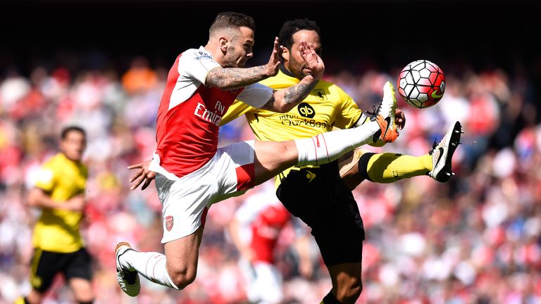 Jack Wilshere of Arsenal and Joleon Lescott of Aston Villa compete for the ball during the Barclays Premier League match b