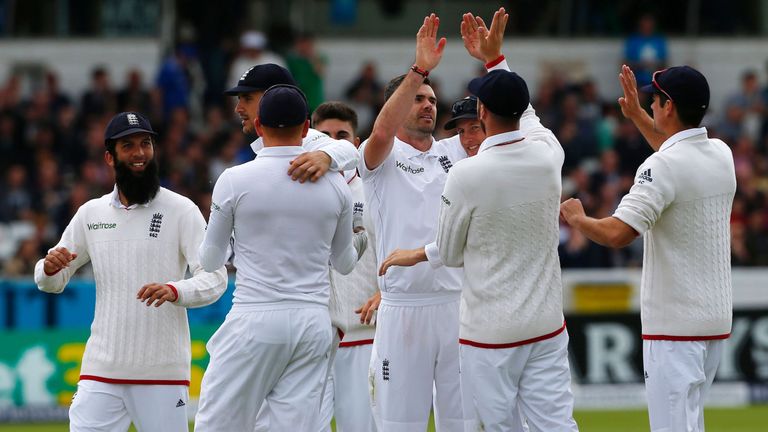 England's James Anderson (C) celebrates with teammates after taking the wicket of Sri Lanka's Kaushal Silva on the third day of the first cricket Test