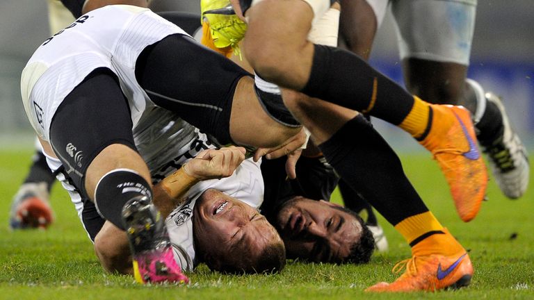 Sharks' flanker Jean Deysel (L) falls after a tackle from Jaguares' hooker Agustin Creevy.