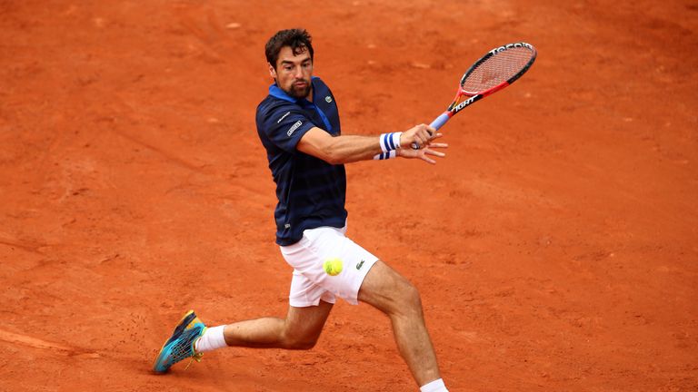 Jeremy Chardy of France plays a backhand at the French Open