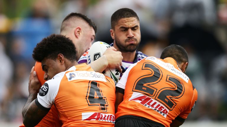 Jesse Bromwich of the Storm is tackled during the round seven NRL match between the Wests Tigers and the Melbourne Storm