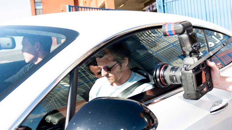 Joey Barton (centre) leaves Ibrox with Rangers assistant manager David Weir