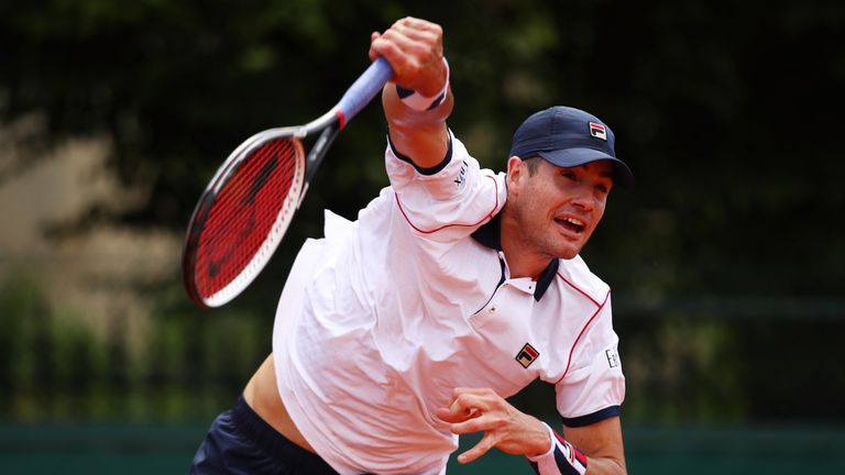 John Isner of the United States serves during his French Open match against Kyle Edmund of Great Britain