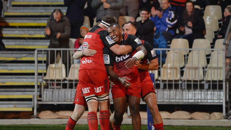 Jone Macilai of the Crusaders (C) and his team-mates celebrate scoring a try during the round 11 Super Rugby match v Reds