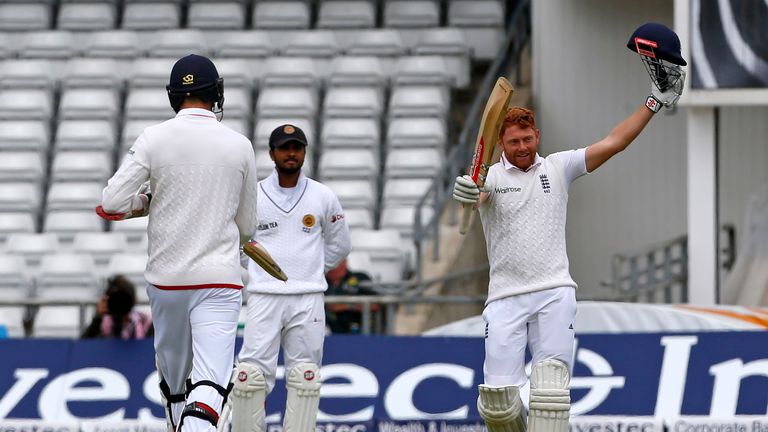 England's Jonny Bairstow (R) celebrates after reaching his century on day two of the first Test