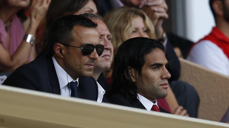 Monaco's Colombian forward Radamel Falcao (R) and his agent Jorge Mendes (L) watch from the tribunes the French L1 football match Monaco (ASM) vs Lille (LO