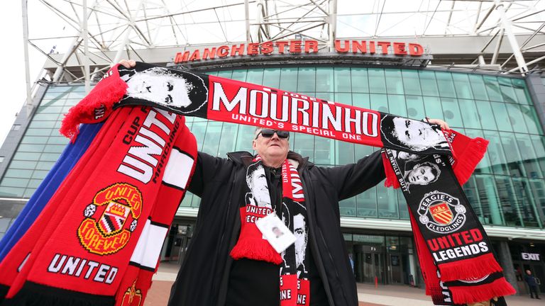 Scarf seller holds up a Jose Mourinho Manchester United scarf outside Old Trafford, Manchester