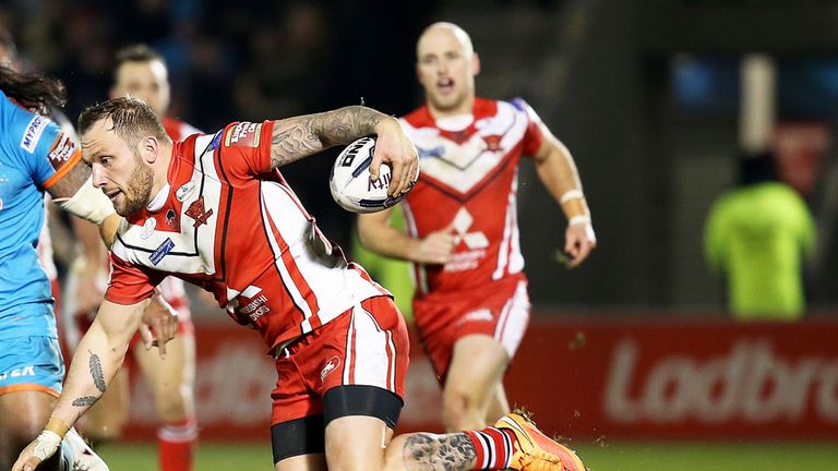 Josh Griffin of Salford is tackled during a Super League game against St Helens