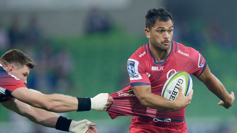 Karmichael Hunt of the Reds evades a tackle