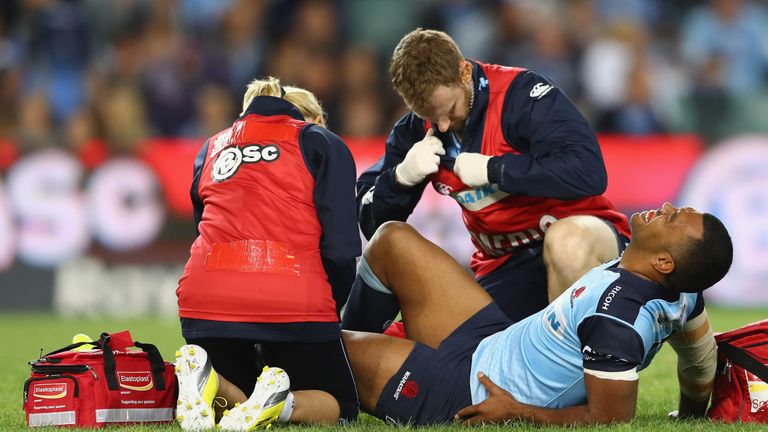 Kurtley Beale is treated after landing awkwardly in the opening seconds of NSW Waratahs' game against the Bulls