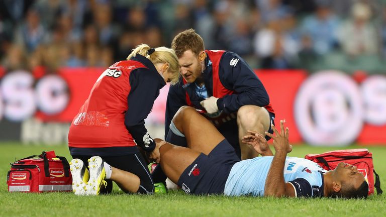 Kurtley Beale of the Waratahs grimaces as he receives attention for an injury