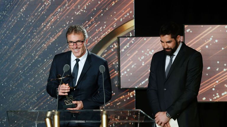 Paris-Saint-Germain's French coach Laurent Blanc (L) receives the Ligue 1 2015-2016 manager of the year award