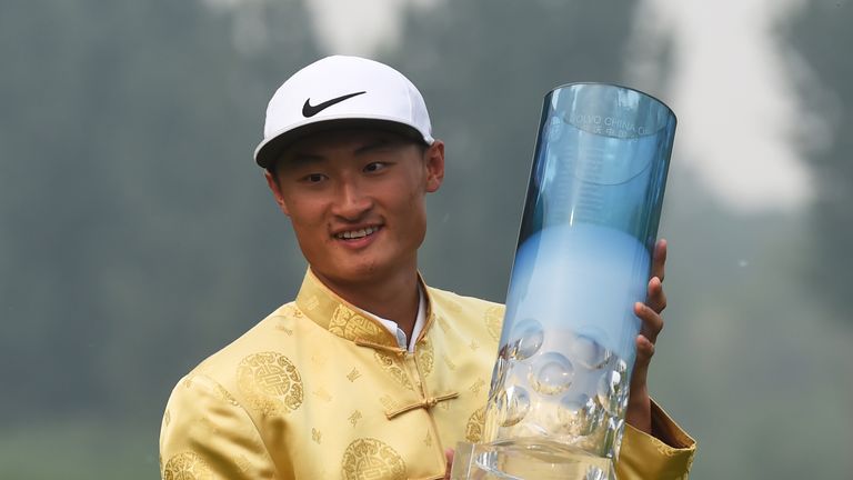 Li Hao-tong of China holds the trophy after winning the Volvo China Open