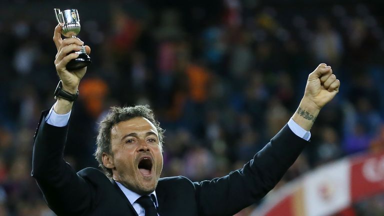 Barcelona's coach Luis Enrique holds a cup as he celebrates after winning the Spanish "Copa del Rey" (King's Cup) final match FC Barcelona vs Sevilla FC at