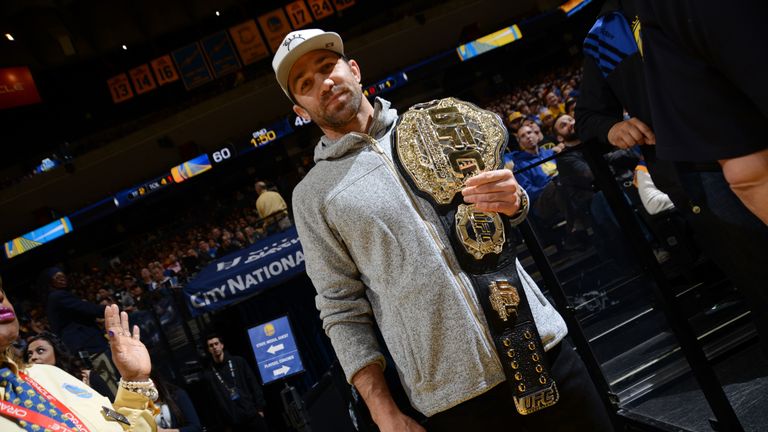 UFC Middleweight champion Luke Rockhold watches the Charlotte Hornets face the Golden State Warriors on January 4, 2016 at Oracle 