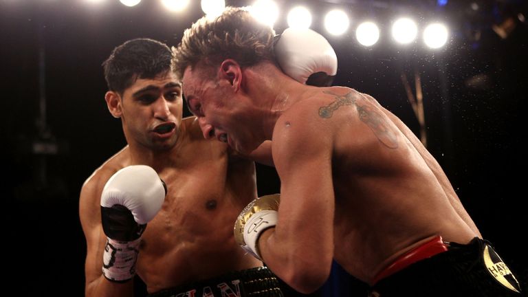 NEW YORK - MAY 15:  Amir Khan (L) of Great Britain hits Paulie Malignaggi during the WBA light welterweight title fight at Madison Square Garden on May 15,