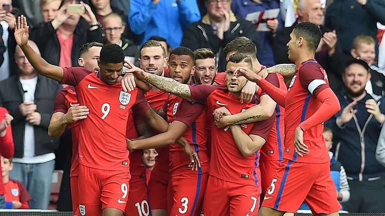England's striker Marcus Rashford (2nd L) celebrates after scoring his team's first goal during the International friendly football match between England a