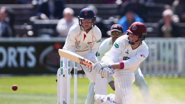 Marcus Trescothick of Somerset sweeps as wicketkeeper Alex Davies looks on during day four of the Specsavers County Championship