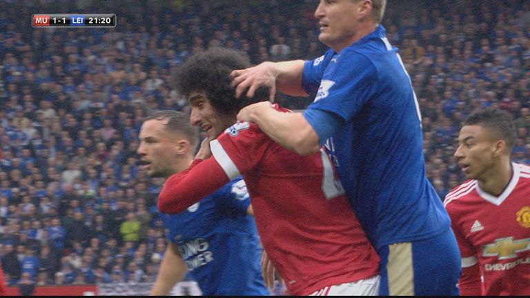 Marouane Fellaini clashes with Robert Huth during Manchester United's Premier League game against Leicester