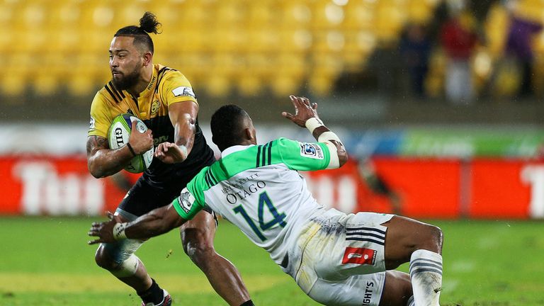 WELLINGTON, NEW ZEALAND - MAY 27:  Matt Proctor of the Hurricanes fends Waisake Naholo of the Highlanders during the round 14 Super Rugby match between the