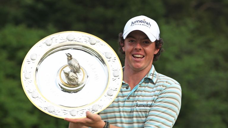  Rory McIlroy of Northern Ireland poses with the winner's trophy after his four-stroke victory at the 2010 Quail Hollow Championshi
